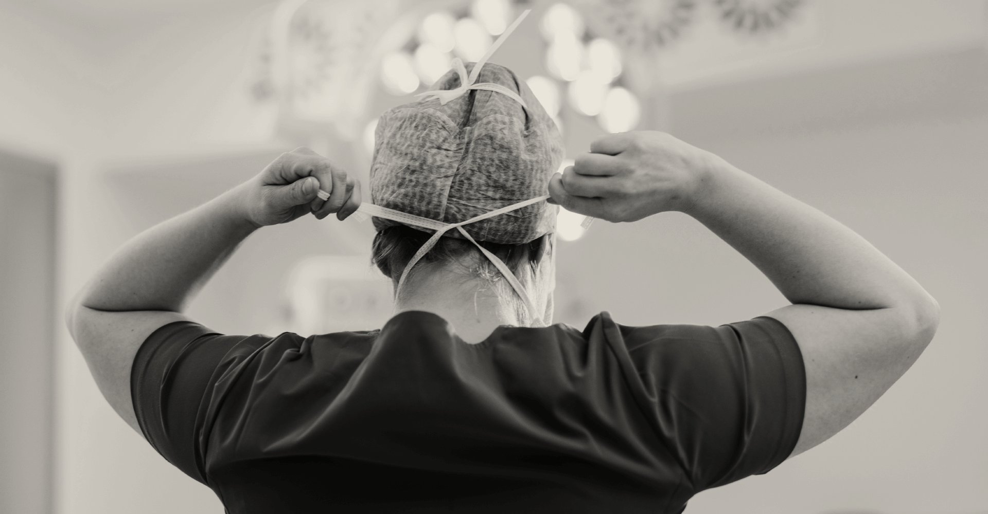 Clinician tying mask